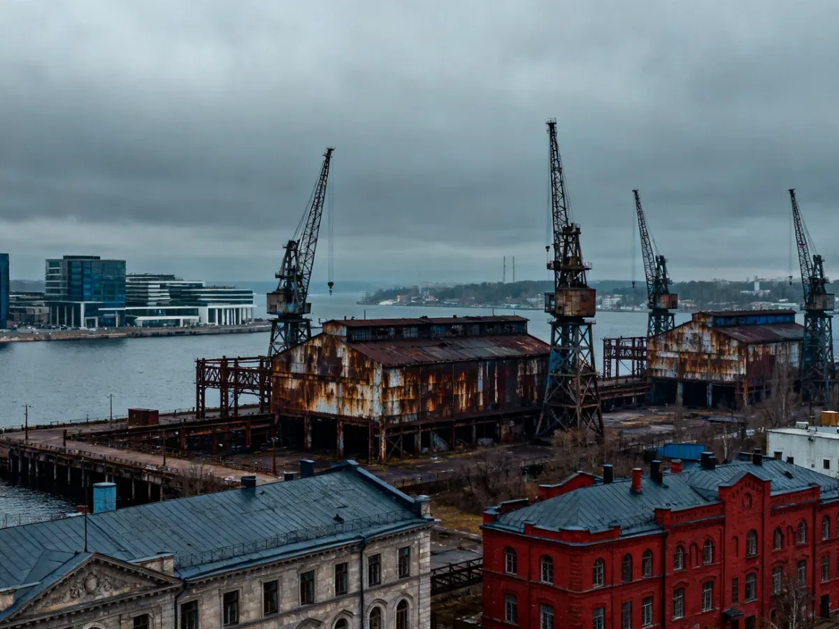 Industrial panorama of Gdansk Shipyard with cranes, rusted steel and historic halls